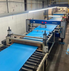 Thin blue foam on a conveyor belt.